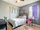 Bright bedroom with gray walls, decorative vines, and a window for natural light at 10153 Gasparilla Rd, Placida, FL 33946