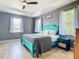 Bright bedroom with tray ceiling, a large bed, and windows with natural light at 10153 Gasparilla Rd, Placida, FL 33946