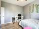 Bedroom featuring hardwood floors, gray walls, and a desk with a computer at 10153 Gasparilla Rd, Placida, FL 33946
