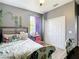 Cozy bedroom with gray walls, closet, and matching pink desk and chair at 10153 Gasparilla Rd, Placida, FL 33946