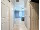 Hallway view of bedroom with neutral colored walls, a ceiling fan and an exterior window at 10153 Gasparilla Rd, Placida, FL 33946