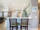 View of kitchen featuring bar seating, stainless steel appliances and sage green cabinetry at 10153 Gasparilla Rd, Placida, FL 33946