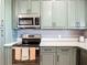 Modern kitchen featuring stainless steel appliances, plenty of cabinet space and white countertops at 10153 Gasparilla Rd, Placida, FL 33946