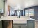 Bright kitchen features a farmhouse sink with modern black faucet and stainless steel dishwasher at 10153 Gasparilla Rd, Placida, FL 33946