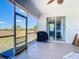 Screened-in lanai with tile flooring, offering views of the surrounding greenery at 10153 Gasparilla Rd, Placida, FL 33946