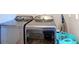 Stainless steel washing machine and dryer with a teal basket at 10153 Gasparilla Rd, Placida, FL 33946