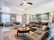 Open-concept living area with a large sectional sofa, view of the kitchen, and abundant natural light at 10153 Gasparilla Rd, Placida, FL 33946