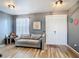 Cozy living room featuring wood floors, a comfortable sofa, and a decorative pineapple print on the wall at 10153 Gasparilla Rd, Placida, FL 33946