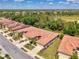 Birds eye view of property with tile roof and manicured lawns in a tranquil community at 11186 Batello Dr, Venice, FL 34292