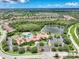 An aerial view showcases the community pools, lakes and beautifully landscaped areas of Venetian Falls at 11186 Batello Dr, Venice, FL 34292