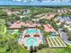 Aerial view of the community featuring a pool, amenity center, bocce ball, putting green, and beautifully maintained landscaping at 11186 Batello Dr, Venice, FL 34292