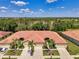 Aerial shot of two homes with tile roofs, palm trees, and landscaped yards at 11186 Batello Dr, Venice, FL 34292