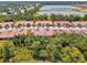 Aerial view of the property with mature landscaping and surrounding trees at 11186 Batello Dr, Venice, FL 34292