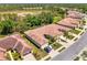 An aerial view shows the property with tile roof, landscaping, and adjacent ponds in a community setting at 11186 Batello Dr, Venice, FL 34292