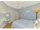 Comfortable bedroom with natural light, wood floors, and closet space at 11186 Batello Dr, Venice, FL 34292