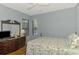 A bright bedroom with natural light and a dresser with a mirror at 11186 Batello Dr, Venice, FL 34292