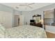 This is a primary bedroom with wood floors, neutral walls, and access to the bathroom at 11186 Batello Dr, Venice, FL 34292