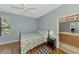 Bright bedroom with wood floors and a glimpse of the attached bathroom at 11186 Batello Dr, Venice, FL 34292