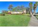 Welcome to Venetian Falls, with beautifully landscaped entrance featuring lush greenery and decorative signage at 11186 Batello Dr, Venice, FL 34292