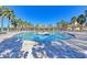 The spacious community pool offers a relaxing experience, complete with poolside seating and a central fountain at 11186 Batello Dr, Venice, FL 34292