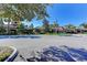 Community clubhouse with lush landscaping and decorative architectural details at 11186 Batello Dr, Venice, FL 34292