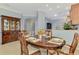 Elegant dining area featuring a wood table, china cabinet, and open floorplan at 11186 Batello Dr, Venice, FL 34292
