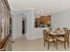 Charming dining room with wood table and seating, open to modern kitchen at 11186 Batello Dr, Venice, FL 34292