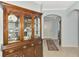 Elegant foyer with tile flooring, a large wooden china cabinet, and views into other rooms at 11186 Batello Dr, Venice, FL 34292