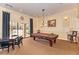 Game room featuring a pool table, card table, and comfortable seating at 11186 Batello Dr, Venice, FL 34292