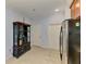 Hallway near kitchen features a dark cabinet at 11186 Batello Dr, Venice, FL 34292