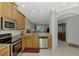 Open concept kitchen with modern stainless steel appliances and granite countertops at 11186 Batello Dr, Venice, FL 34292