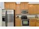 Spacious kitchen features stainless steel appliances, granite countertops, and wood cabinets at 11186 Batello Dr, Venice, FL 34292