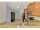 This kitchen shows stainless steel appliances, granite countertops, and modern lighting at 11186 Batello Dr, Venice, FL 34292