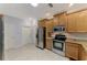 Modern kitchen boasts stainless steel appliances, tile flooring, and ample natural light at 11186 Batello Dr, Venice, FL 34292