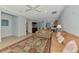 Spacious living room with neutral tile flooring, a ceiling fan, and view of dining area at 11186 Batello Dr, Venice, FL 34292