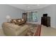 A cozy living room featuring comfortable seating, a ceiling fan, and a decorative rug at 11186 Batello Dr, Venice, FL 34292