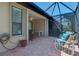 Screened in patio with brick flooring and comfortable seating, offering a relaxing outdoor space at 11186 Batello Dr, Venice, FL 34292