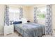 Bedroom featuring a window, and decorative curtains, offering a cozy atmosphere at 1124 W Hillsborough Blvd, North Port, FL 34288