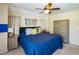Cozy bedroom featuring a ceiling fan, comfortable queen bed, and tasteful decor at 1124 W Hillsborough Blvd, North Port, FL 34288