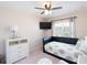 Bedroom with TV, ceiling fan, daybed, dresser and carpet floors at 1124 W Hillsborough Blvd, North Port, FL 34288