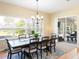 Bright dining room with large windows, modern chandelier and comfortable seating at 1124 W Hillsborough Blvd, North Port, FL 34288