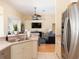 Open concept kitchen with stainless steel refrigerator and view into the living room at 1124 W Hillsborough Blvd, North Port, FL 34288