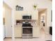 Updated kitchen featuring stainless steel appliances and stylish tile backsplash at 1124 W Hillsborough Blvd, North Port, FL 34288