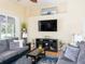 Spacious living room with mounted TV, stylish decor and lots of natural light at 1124 W Hillsborough Blvd, North Port, FL 34288