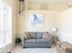 Cozy living area features a comfy sofa, stylish decor, and natural light streaming through the window at 1124 W Hillsborough Blvd, North Port, FL 34288