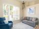 Cozy living room with comfortable seating, large window and decorative octopus art piece at 1124 W Hillsborough Blvd, North Port, FL 34288