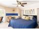 Spacious main bedroom with a ceiling fan, en-suite bathroom, and natural light at 1124 W Hillsborough Blvd, North Port, FL 34288