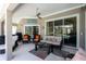 Spacious screened patio with a ceiling fan, comfortable seating, and stylish decor at 1124 W Hillsborough Blvd, North Port, FL 34288