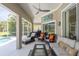 Relaxing screened patio with comfortable seating, ceiling fan, and access to the pool area at 1124 W Hillsborough Blvd, North Port, FL 34288