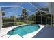 Sparkling pool surrounded by a screened enclosure offering privacy and protection from insects at 1124 W Hillsborough Blvd, North Port, FL 34288
